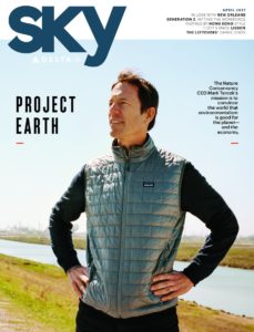 cover of delta sky magazine shows picture of mark tercek standing by river
